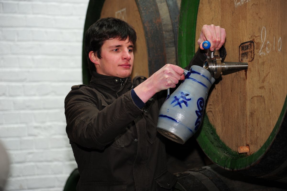 Michaël 'Mich' Blancquaert taps some fresh lambic from the barrel.